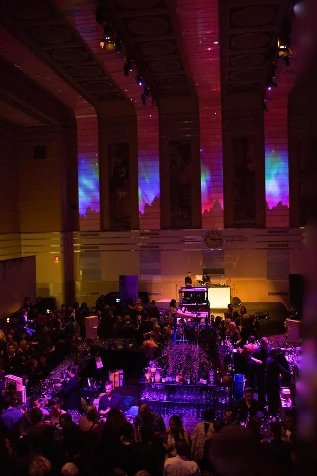 Design Exchange Gala pre-midnight scene with gala guests on the floor and projection warming up before the band's midnight cue