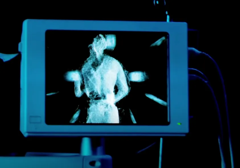 Joseph of Mercury MVA point-cloud figure standing at a terminal, rendered in green depth-scan tones