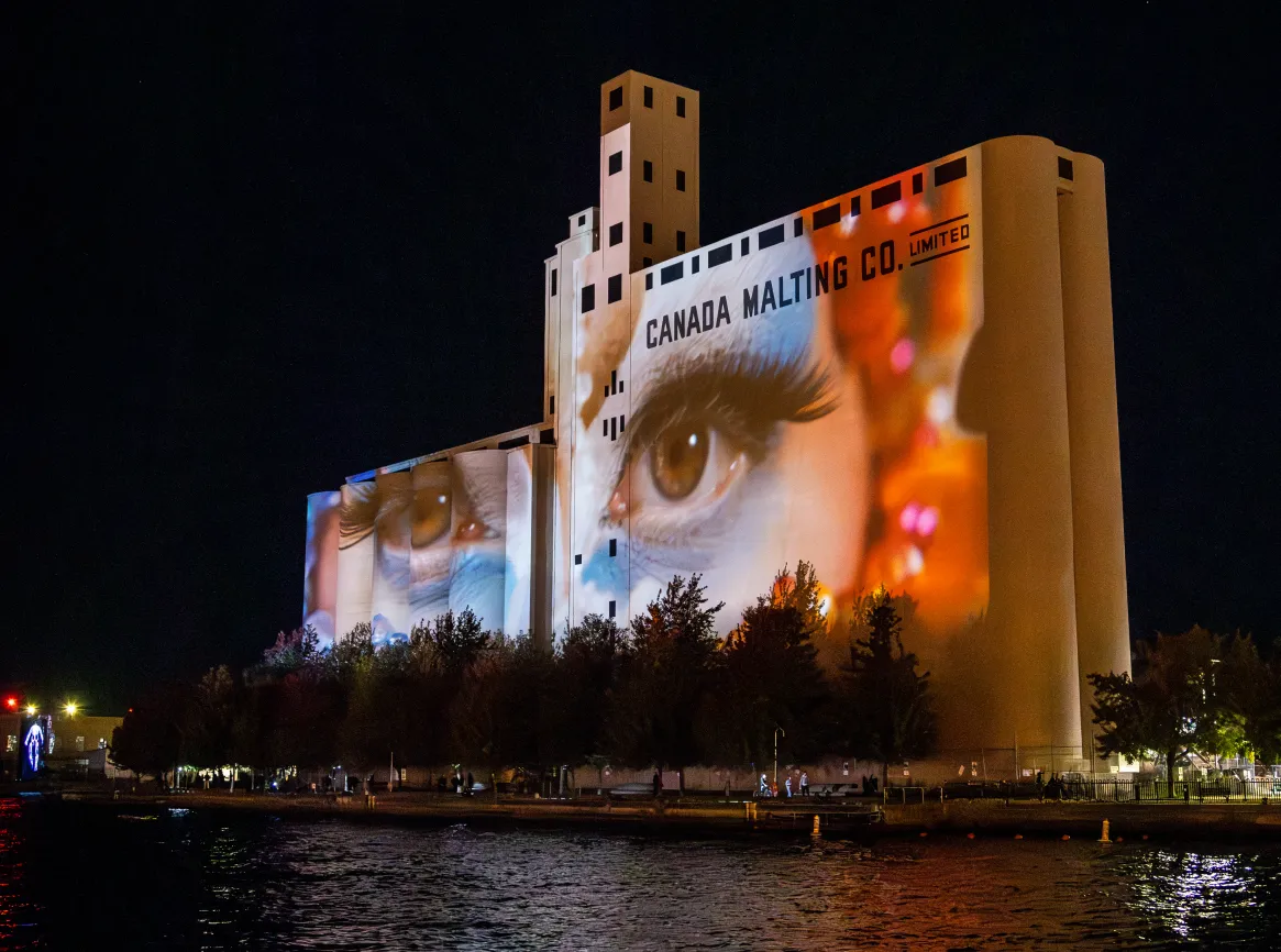 Close-up of the goddess eye motif projected across the silo towers during Riparia at Nuit Blanche 2024