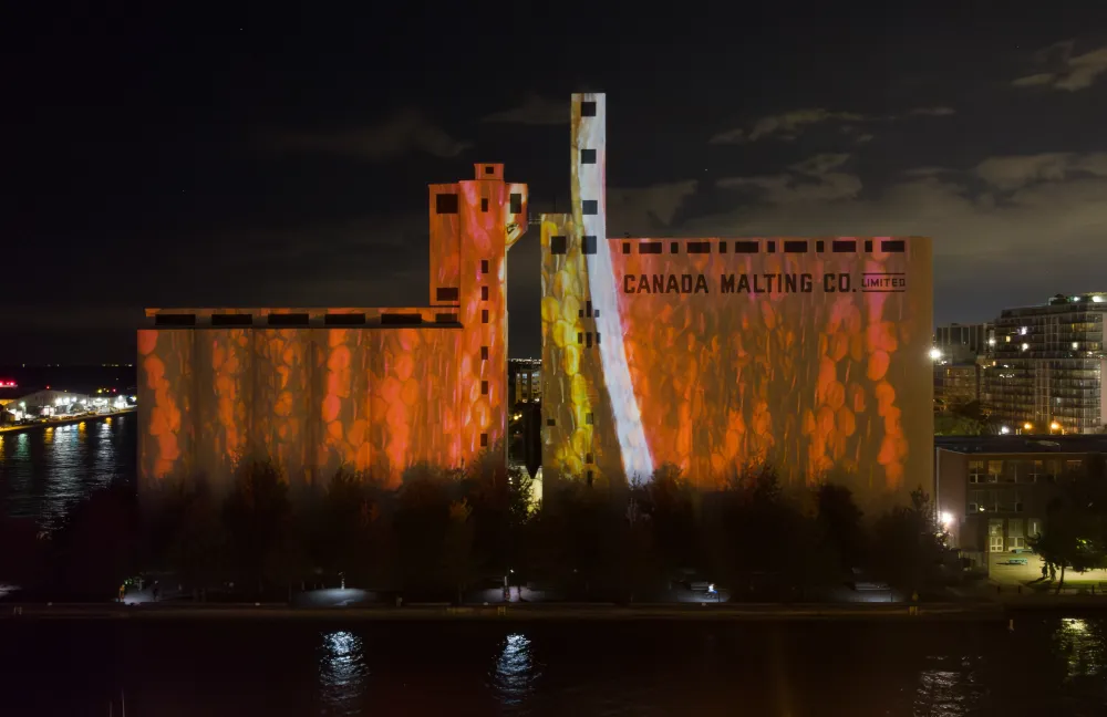 Riparia mid-show with flowing water and marine creature imagery cascading down the silo surface