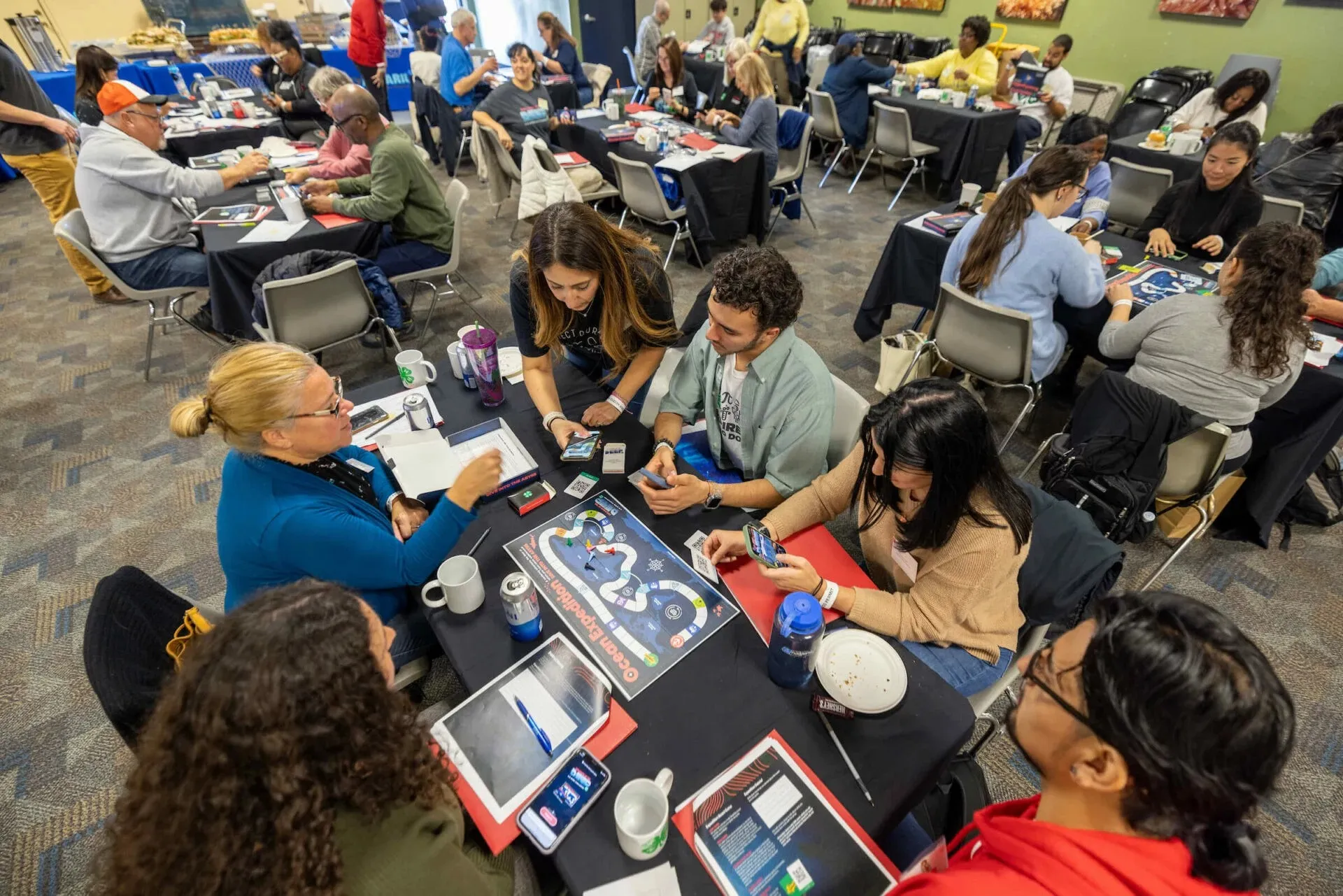 Ocean Expedition AR board game with a tablet held above the physical board, revealing animated undersea creatures through augmented reality