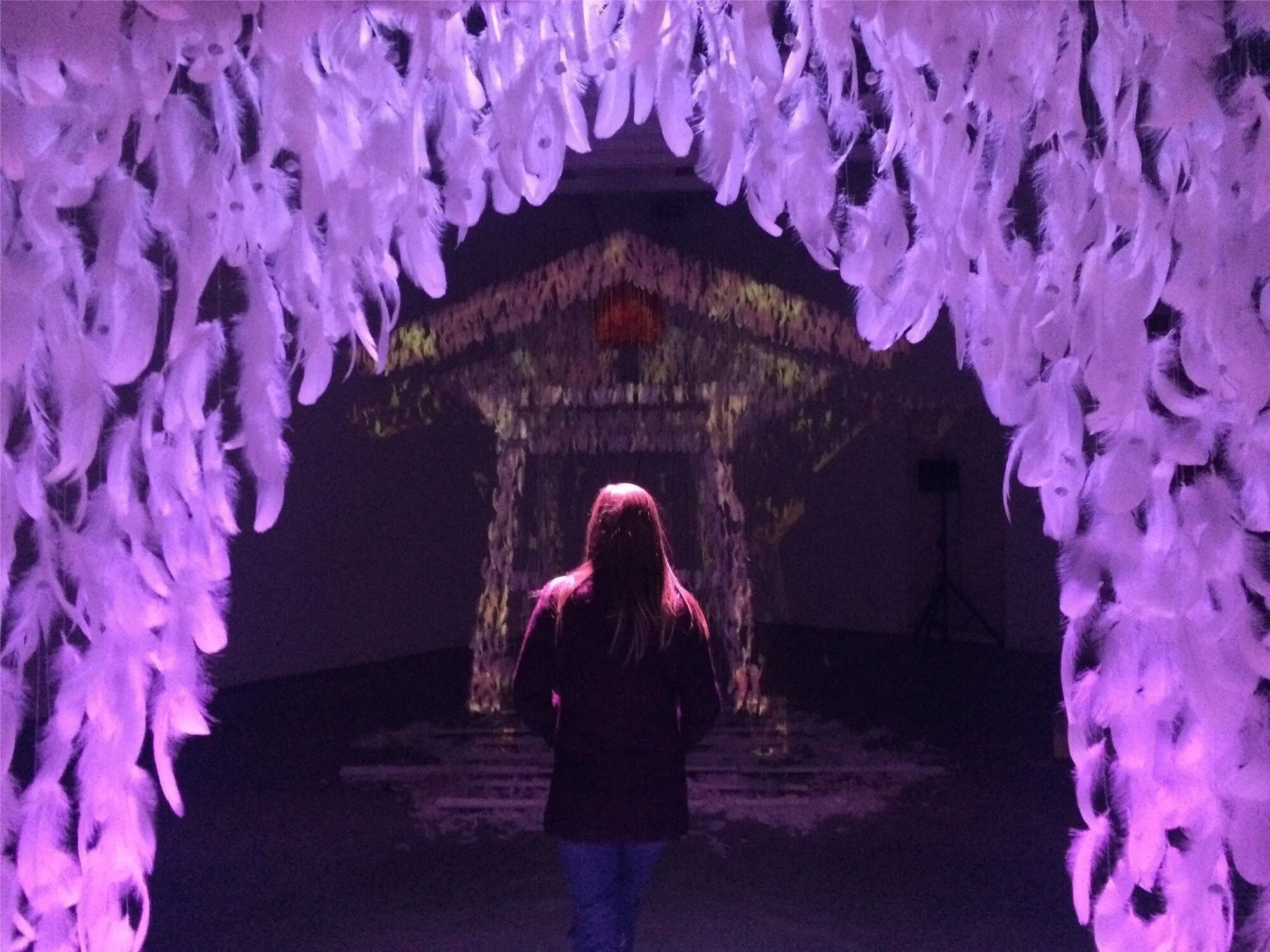 Be Here Now installation overview showing the floating bell and projection-mapped surface in a darkened gallery