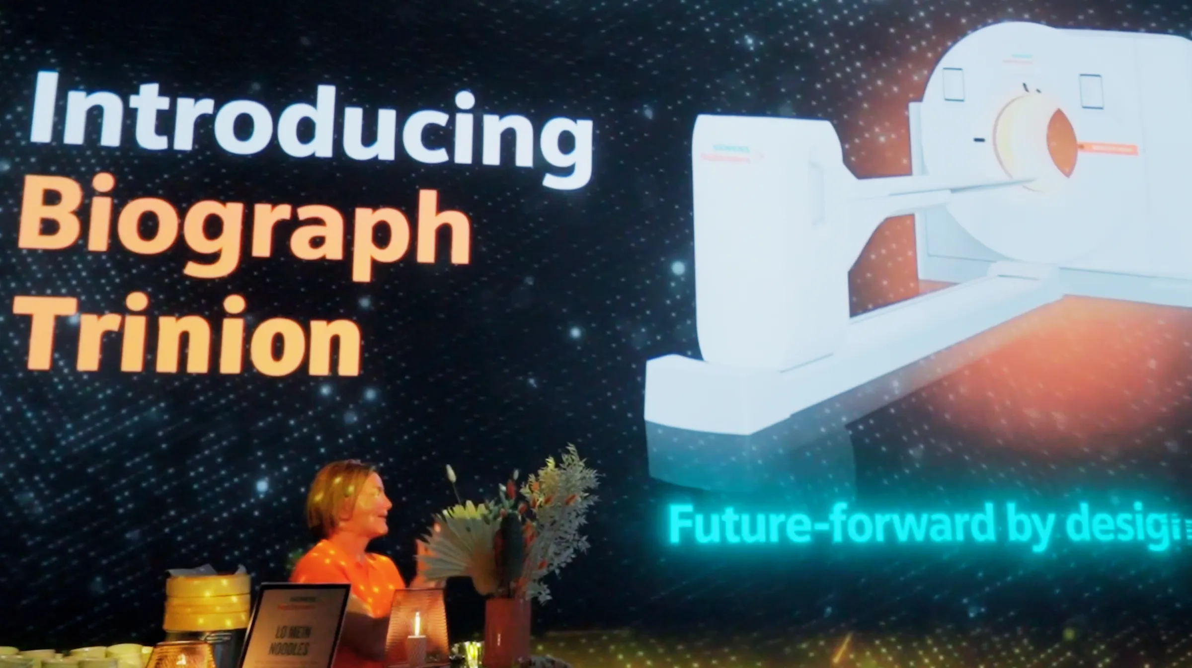 Full-room immersive projection mapping showing Siemens Biograph Trinion scanner visuals at Illuminarium Toronto