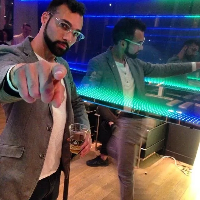 Tyler Sammy beside the illuminated mirrored installation
