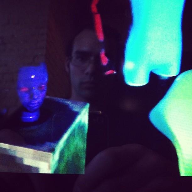 Tyler Sammy in a projection-mapping setup with vivid neon colours